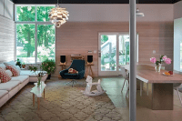 Darling’s redesign of a walkout basement and two-car garage into a spacious mother-in-law loft-style apartment, bathed in natural light and featuring a library with expansive views to lush gardens.