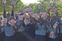 Sexual and reproductive health education and support is critical around the world. Here rural youths celebrate receiving needed supplies.