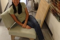 Aleida sitting in a mock-up of a custom chair designed by Thread Collaborative. After confirming all dimensions and judging the chair's overall comfort, the mock-up was approved and moved into production.