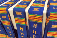 Stoles made of boldly colored kente cloth that is embroidered with “MHC” and special symbols.
