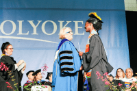 President Sonya Stephens awards Donari Yahzid her degree at Commencement 2019