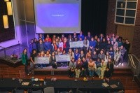 Participating Mount Holyoke faculty and students pose together on stage with AWS awards.