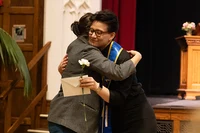 Student and mentor hug during the Stoling Ceremony at Mount Holyoke College in 2026