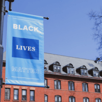 A Black Lives Matter sign hanging on a lamp post on the Mount Holyoke campus