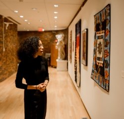 art-gallery-wall-art-museum.jpg A student enjoying a wall of art in the art museum