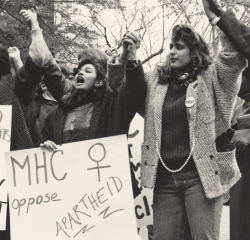 Students holing signs and cheering in protest against apartheid in South Africa