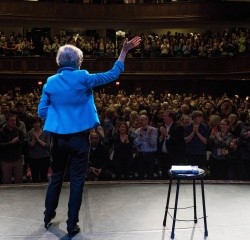 Elizabeth Warren waves to the crowd in Chapin auditorium
