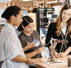 Three students collaborating on a project in the Fimbel Lab