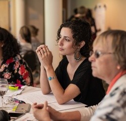 Professional and Graduate students listening attentively to a presentation