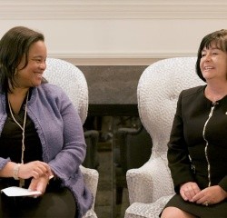 President Holley (left) speaks with Lena Maria Rivero Cashin, class of 1988 and parent to a class of 2019 alum (right).