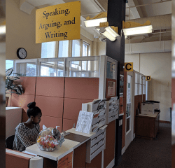 A student works at the SAW Cemter reception desk