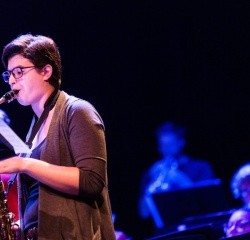 A student playing the saxophone in a concert