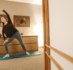 A student stretching on a yoga mat