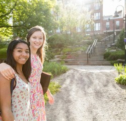Mount Holyoke College students looking at the camera on a spring day on the campus.