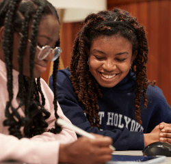 Two students engaged in work on a tablet