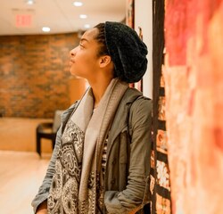 Student leaning at the Art Museum Gallery