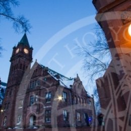 MHC campus at dusk, view from the gate with a lit lantern.