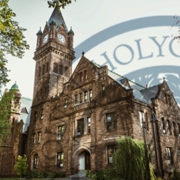 A picture of Mary Lyon Hall with MHC Logo watermarked over it.
