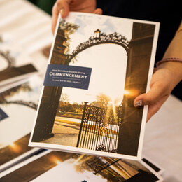 A person holding a Mount Holyoke Commencement program