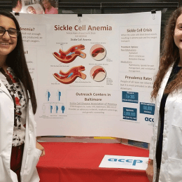 Felicia Harrsch ’14 (right) giving a poster presentation to the community at a public health outreach event