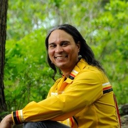 Larry Spotted Crow Mann smiling into the camera