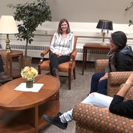 Gwen Coiley ’13 (center) speaks with Community-Based Learning students. Image by Grace Fitzpatrick.