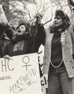 Students holing signs and cheering in protest against apartheid in South Africa