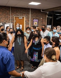 A group of students and guests celebrating during the opening of the relocated Zowie Banteah Cultural Center
