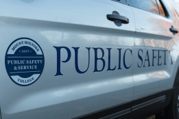 The side of a public safety and service vehicle, with a seal and the words "Public Safety" painted on the doors