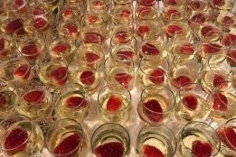 Strawberries in glasses of champagne on a white table