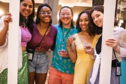 Students pose with &quot;Strawberries and Champagne&quot; polaroid cut out, 2021.