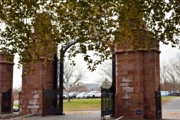 The Gates of Mount Holyoke framed by leaves starting to turn colors.