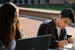 Students working outside on laptops