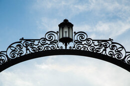 Gates and a blue sky with slight clouds. Photo taken by Ryan Donnell, 2017.