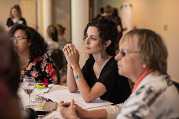 Professional and Graduate students listening attentively to a presentation