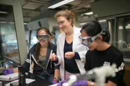 Students working in lab with faculty.