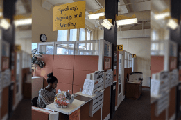 A student works at the SAW Cemter reception desk