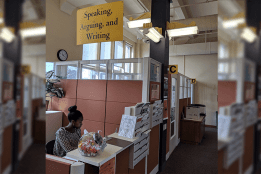 A student works at the SAW Cemter reception desk