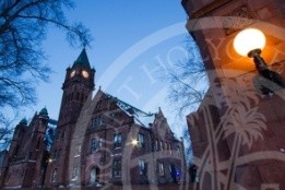 MHC campus at dusk, view from the gate with a lit lantern.
