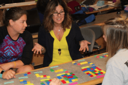 Summer Math - a group of participants discussing with blocks of bright colors in front of them