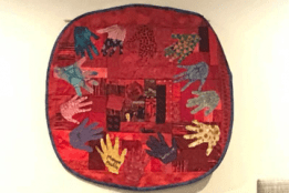 A colorful quilt that hangs in the Unity Center