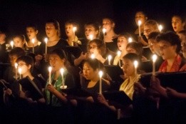 Students singing by candlelight during a Vespers concert