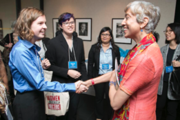 Image of Kavita Ramdas ’85 greeting Mount Holyoke College students.