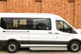 An accessible van parked against a brick wall