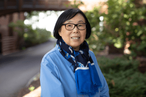 Ying Wang standing outside on the Mount Holyoke College campus