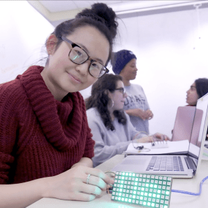 A student showing off an LED computer board