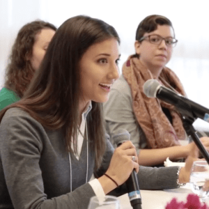 A student answering a question during a panel discussion