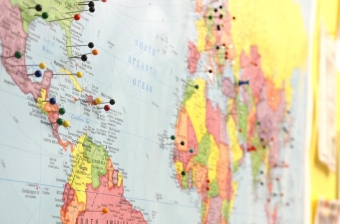 A map of the world with push pins representing out students home countries