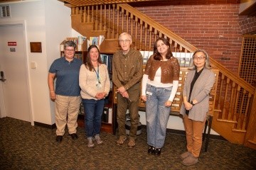 Faculty, staff, and a student pose together for David Crockett Graham archival project.
