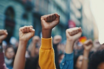 Fisted hands are raised in the air.